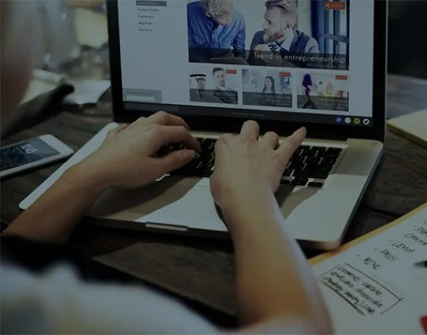 Hands typing on a laptop, symbolising online search for Asian businesses on a directory.